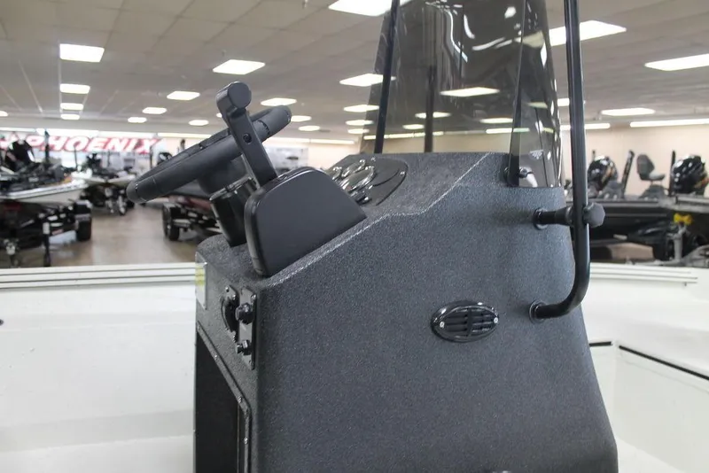 Slide: The Image of 2025 Excel Bay Pro Elite 183 boat console in showroom, featuring steering wheel and controls. - 8