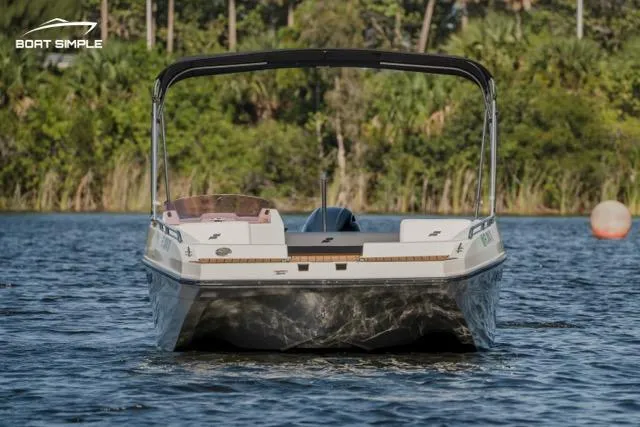 Slide: The Image of 2022 Starcraft SVX 171 OB boat on a serene lake with lush greenery. - 2