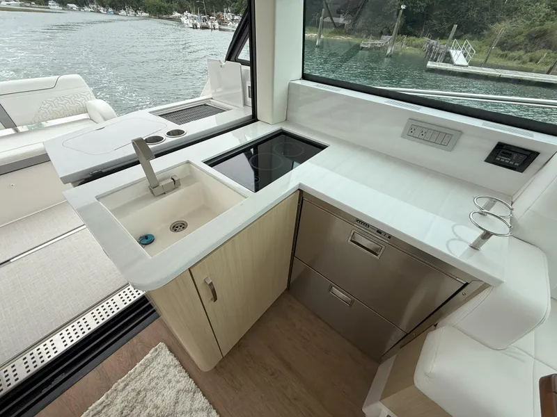 Slide: The Image of Modern kitchen area on 2025 Regal 38 FXO yacht with sink and stove. - 17