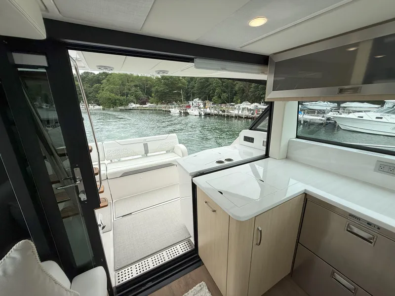 Slide: The Image of Interior view of 2025 Regal 38 FXO yacht with open deck and water scenery. - 18