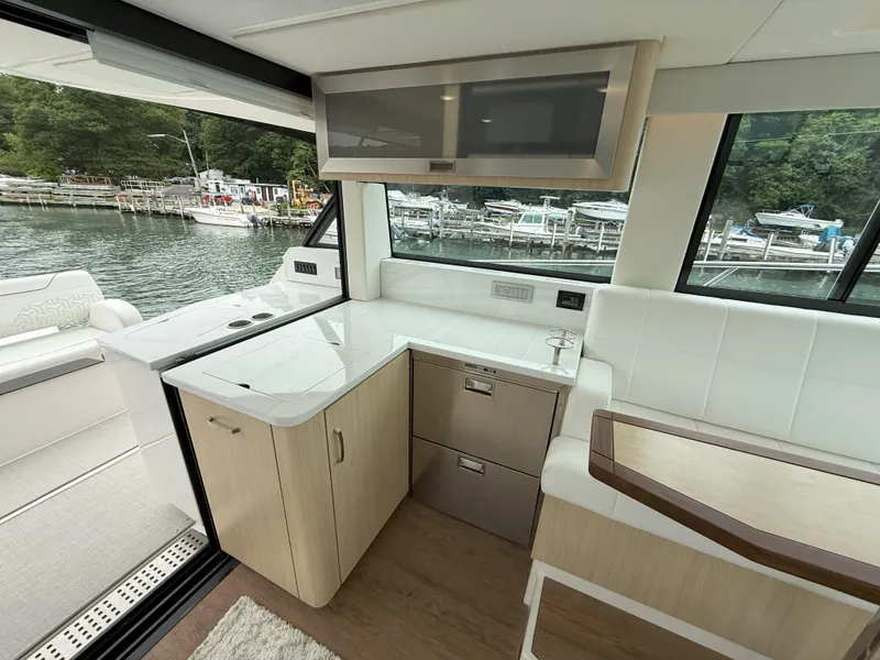 Slide: The Image of Luxurious interior of 2025 Regal 38 FXO yacht with modern kitchen and scenic water view. - 20