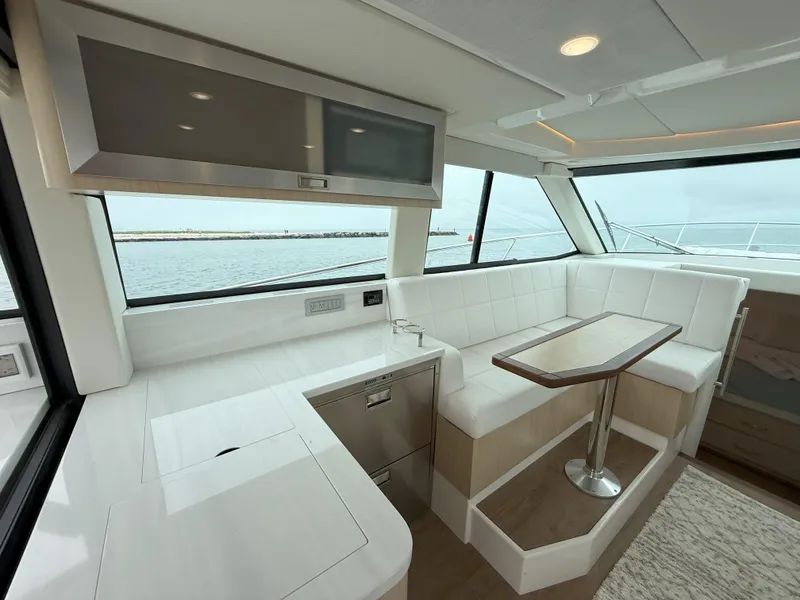 Slide: The Image of Luxurious interior of 2025 Regal 38 FXO yacht with modern seating and dining area. - 21