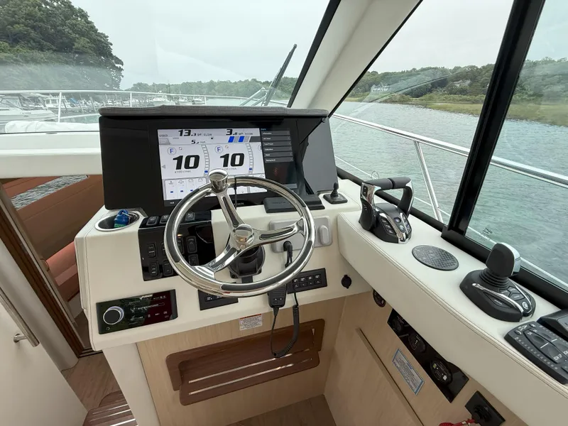 Slide: The Image of Helm of 2025 Regal 38 FXO boat with modern controls and navigation displays. - 23