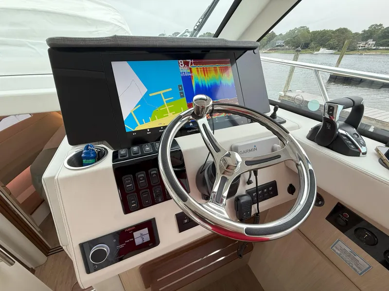 Slide: The Image of Helm of 2025 Regal 38 FXO yacht with Garmin navigation system and modern controls. - 24
