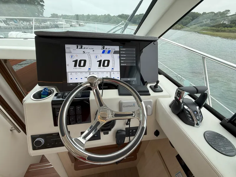 Slide: The Image of Helm of 2025 Regal 38 FXO boat with Garmin navigation system and controls. - 25