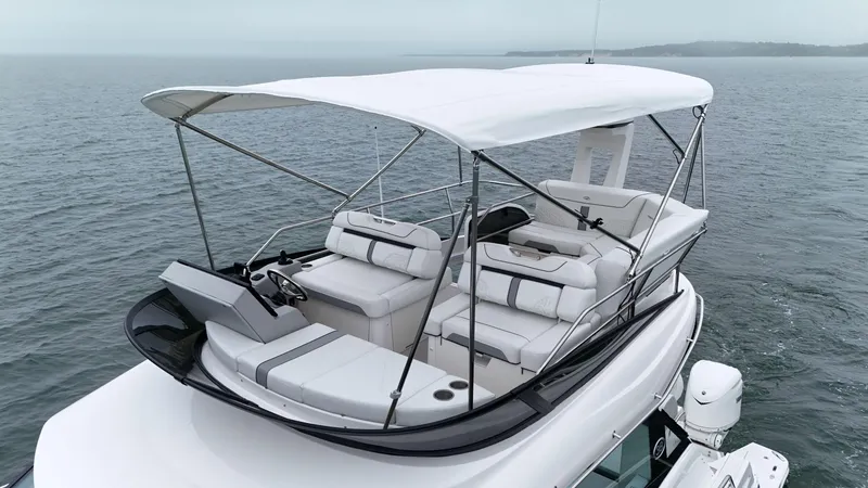Slide: The Image of 2025 Regal 38 FXO yacht with spacious seating and canopy on open water. - 27
