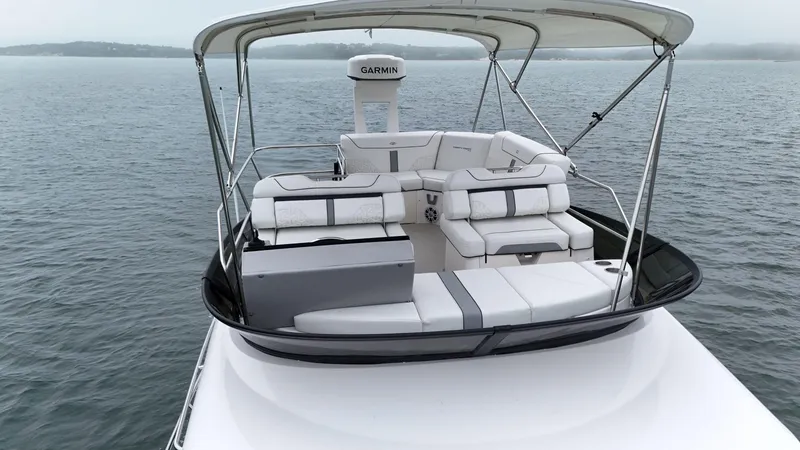 Slide: The Image of 2025 Regal 38 FXO boat with spacious seating on calm waters. - 28
