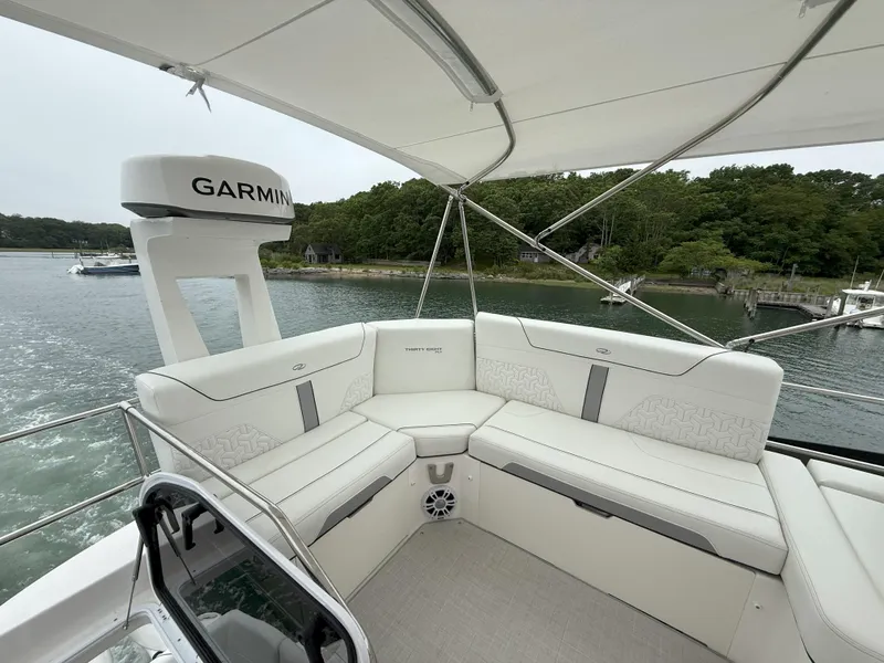 Slide: The Image of Luxurious seating area on 2025 Regal 38 FXO yacht with Garmin equipment, overlooking serene waters. - 29