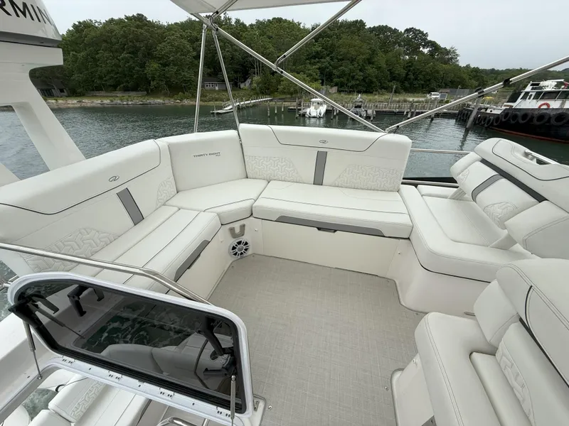 Slide: The Image of Luxurious seating area on a 2025 Regal 38 FXO yacht, docked by a serene waterfront. - 30