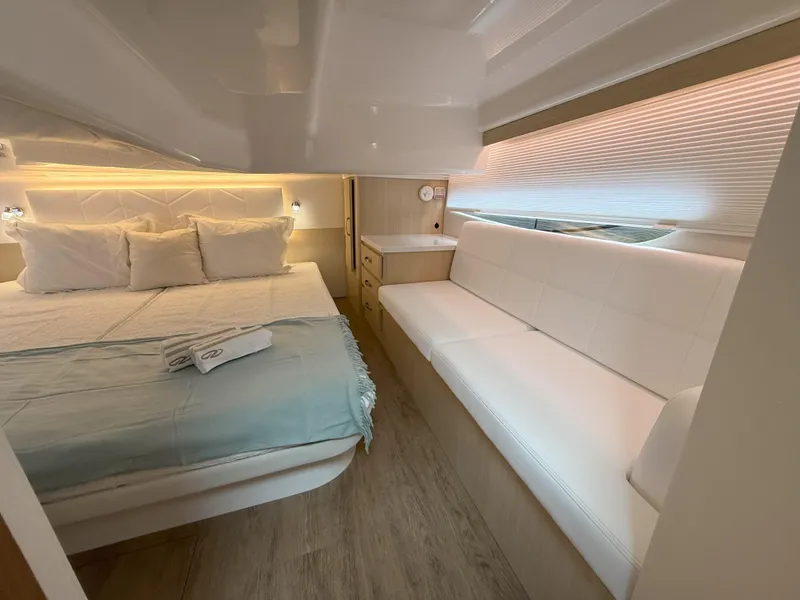 Slide: The Image of Luxurious interior of 2025 Regal 38 FXO yacht with cozy bed and seating area. - 34