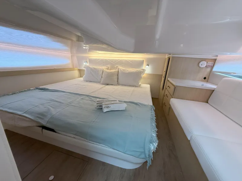 Slide: The Image of Luxurious cabin interior of 2025 Regal 38 FXO yacht with cozy bed and seating. - 35