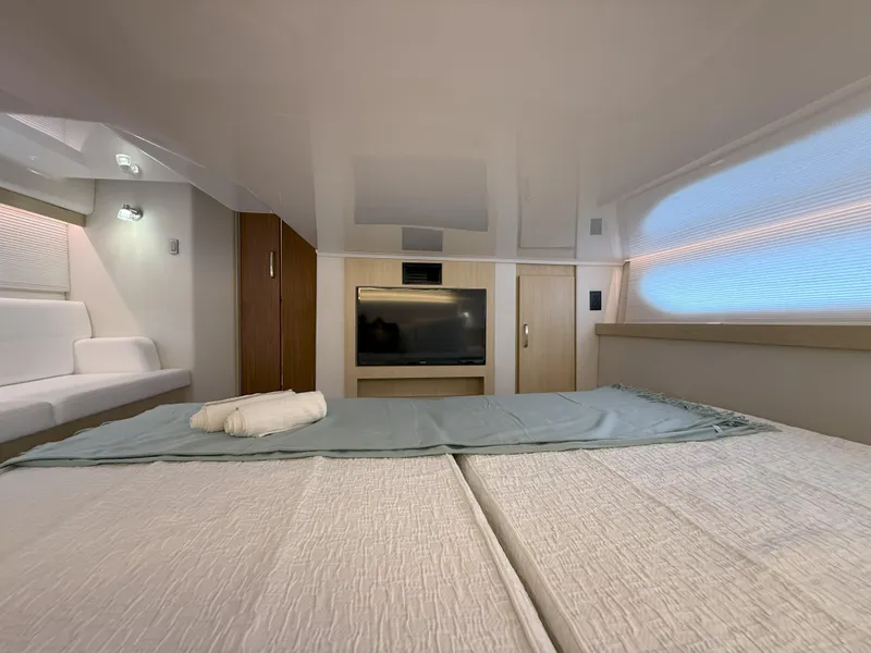 Slide: The Image of Luxurious interior of 2025 Regal 38 FXO yacht with cozy bedding and modern amenities. - 36