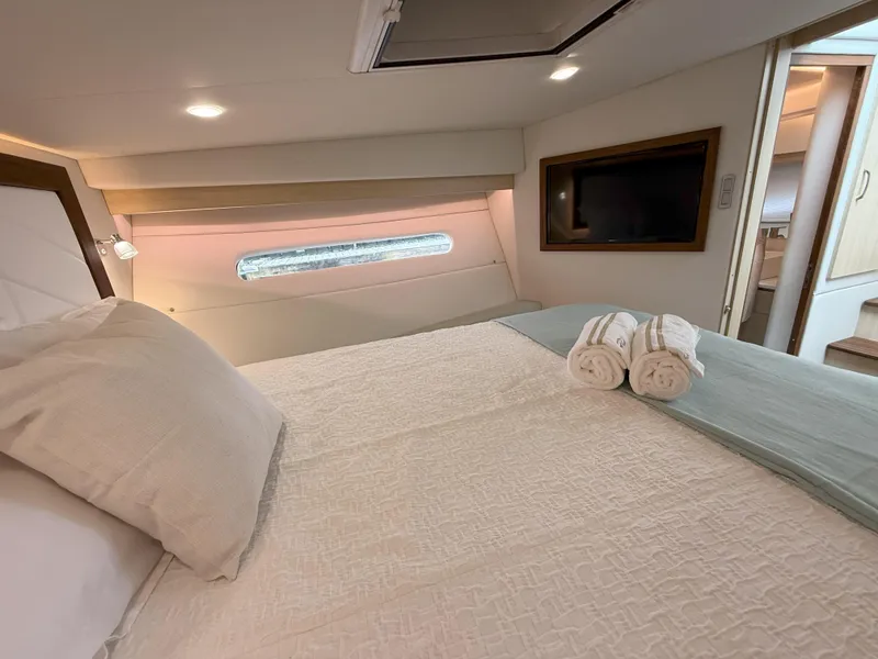 Slide: The Image of Luxurious cabin interior of 2025 Regal 38 FXO yacht with bed and window view. - 37