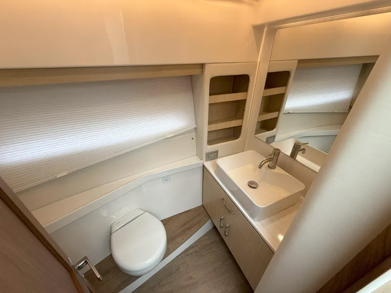 Slide: The Image of Luxurious bathroom in 2025 Regal 38 FXO yacht with modern fixtures and ample storage. - 38