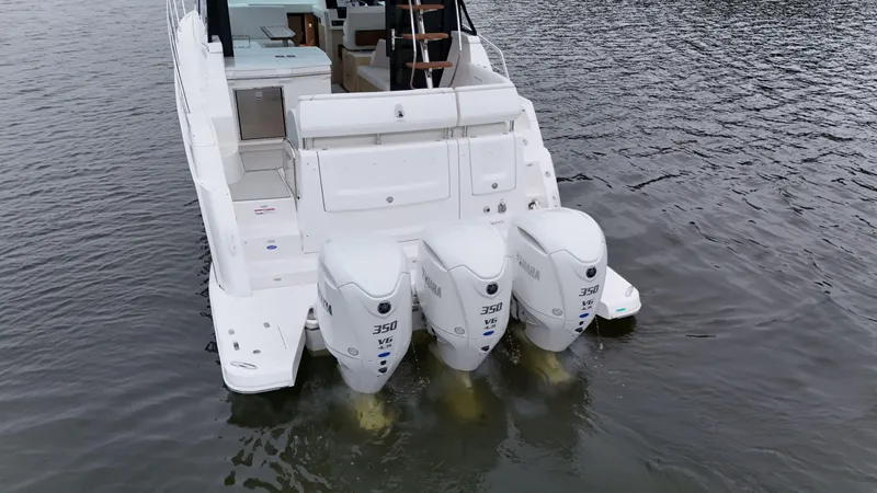 Slide: The Image of 2025 Regal 38 FXO boat with triple Yamaha 350 V6 engines on water. - 8