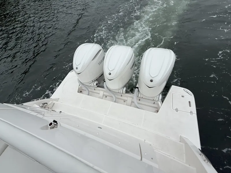 Slide: The Image of 2025 Regal 38 FXO boat with triple outboard engines on water. - 9