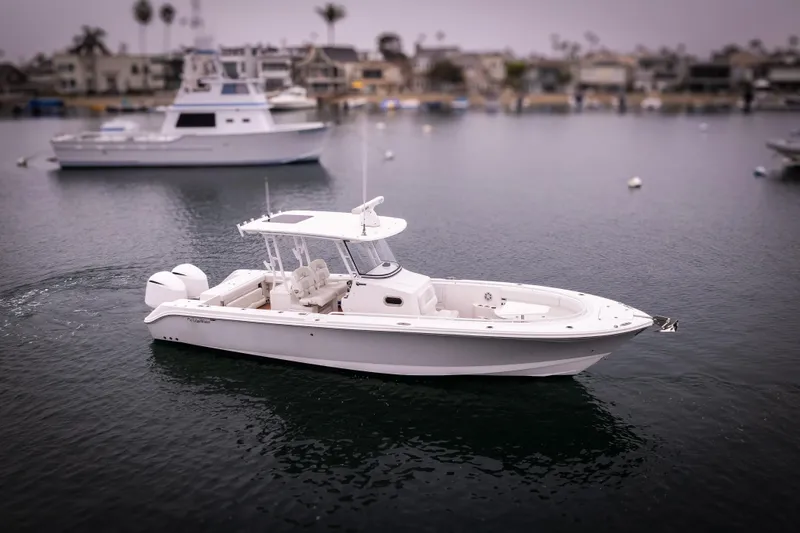 Slide: The Image of 2017 Edgewater Center Console boat on calm water, with marina in background. - 14