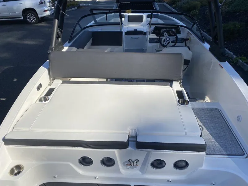 Slide: The Image of 2023 Bayliner DX2050 boat interior with seating and steering wheel. - 16