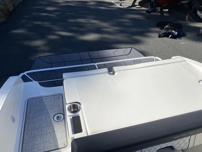 Slide: The Image of 2023 Bayliner DX2050 boat deck with seating and cup holder. - 17