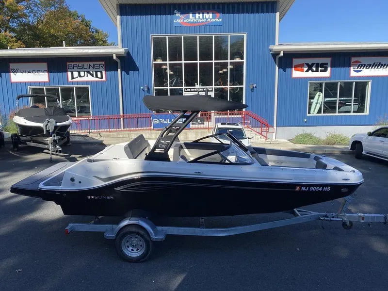Slide: The Image of 2023 Bayliner DX2050 boat on trailer outside dealership. - 22