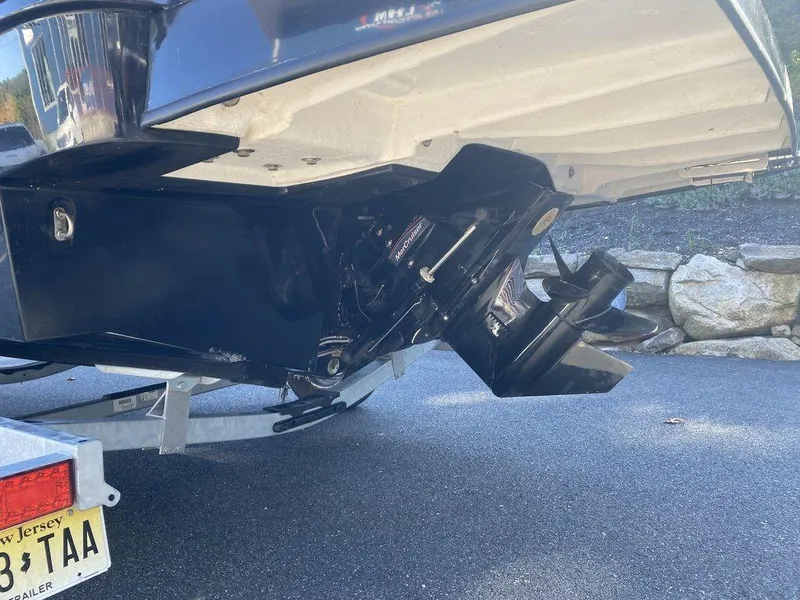 Slide: The Image of 2023 Bayliner DX2050 boat on trailer, showing outboard motor and propeller. - 4