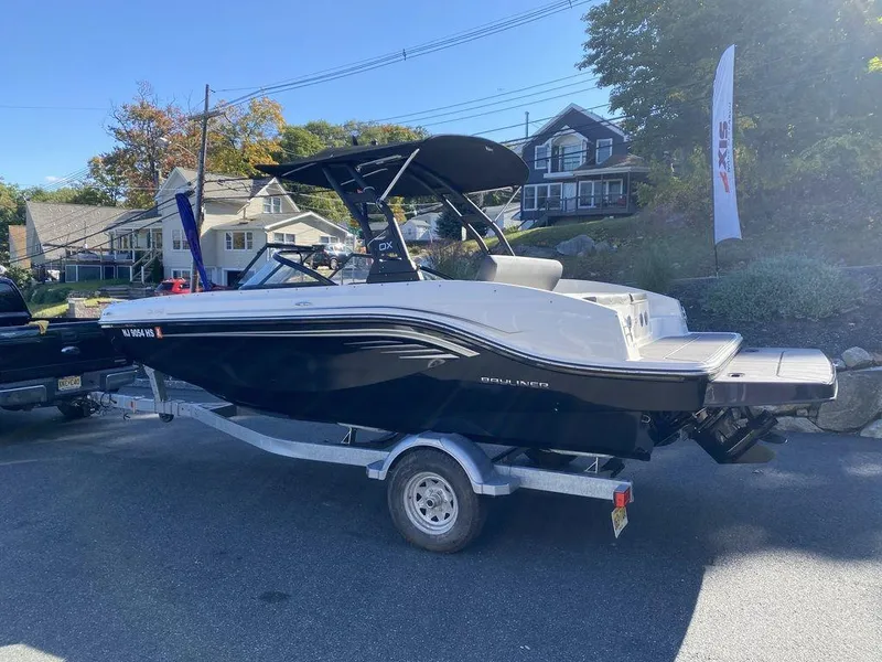 Slide: The Image of 2023 Bayliner DX2050 boat on trailer in residential area. - 5
