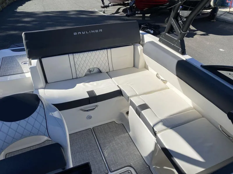 Slide: The Image of 2023 Bayliner DX2050 boat interior with cushioned seating and modern design. - 8