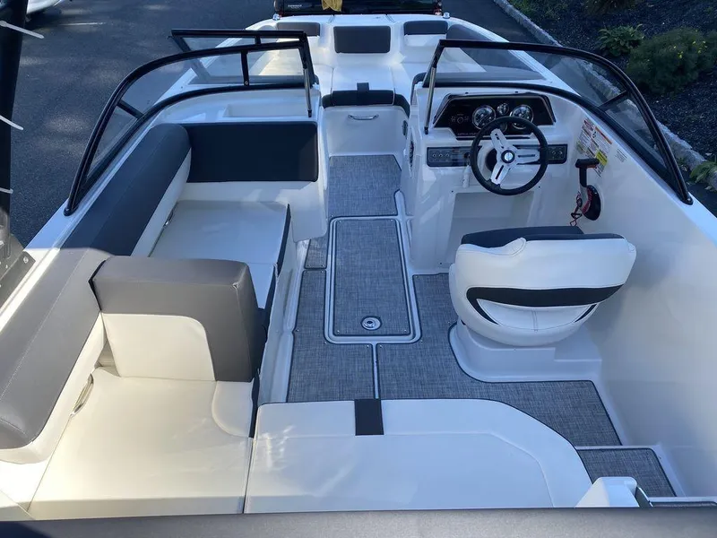 Slide: The Image of 2023 Bayliner DX2050 boat interior with modern seating and steering console. - 9