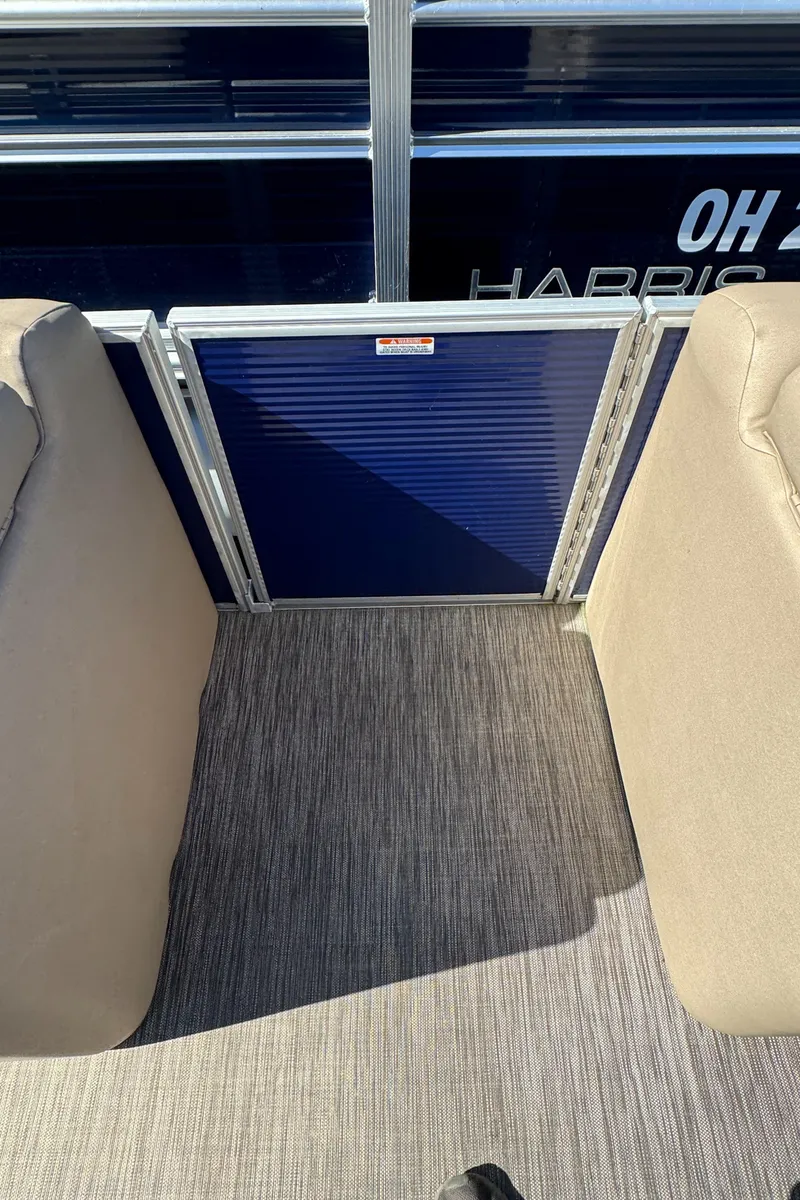 Slide: The Image of Interior view of 2022 Bennington Cruiser 230 boat with beige seating and blue panel. - 15