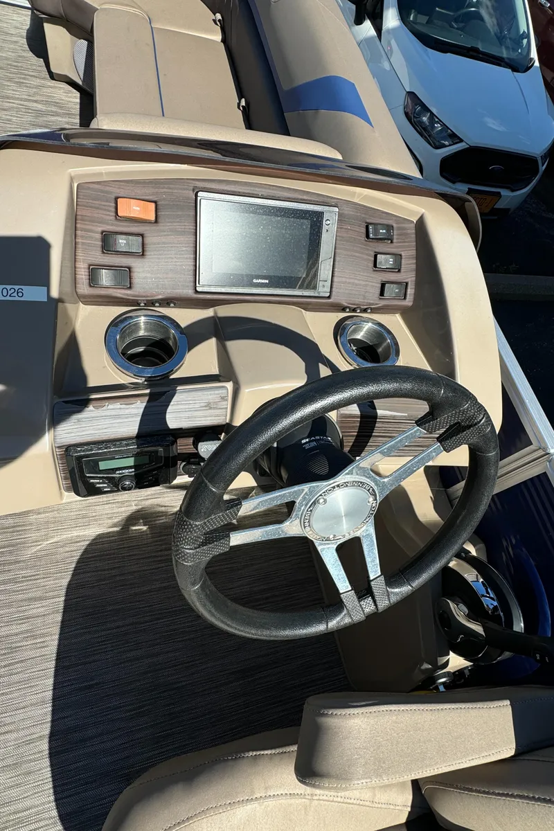 Slide: The Image of 2022 Bennington Cruiser 230 dashboard with steering wheel and control panel. - 16
