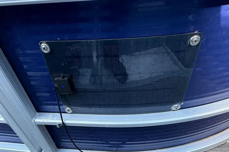 Slide: The Image of 2022 Bennington Cruiser 230 with solar panel attachment on blue exterior. - 23