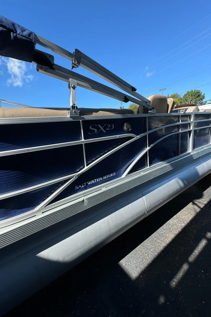 Slide: The Image of 2022 Bennington Cruiser 230 pontoon boat, side view, blue sky background. - 5