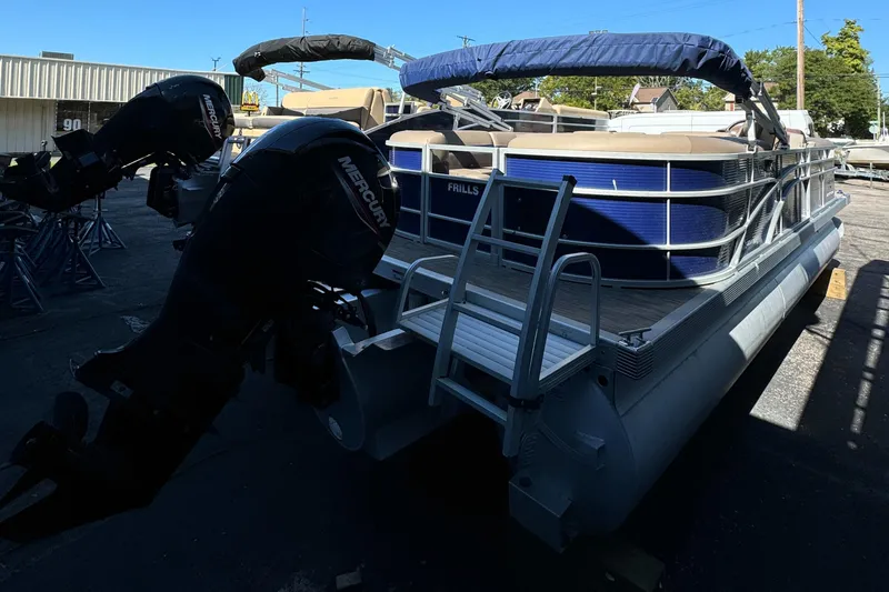 Slide: The Image of 2022 Bennington Cruiser 230 pontoon boat with Mercury outboard motor, docked outdoors. - 6