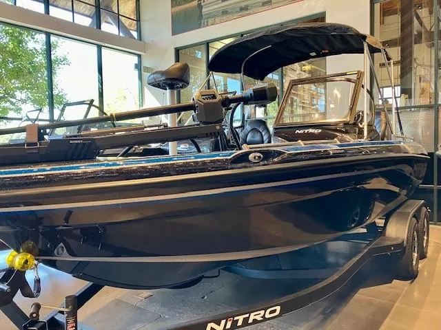 Slide: The Image of 2024 Nitro ZV19 Pro boat displayed indoors, featuring sleek black design and modern equipment. - 1