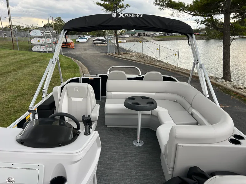 Slide: The Image of 2025 Godfrey Xperience 2086 FX pontoon boat with seating and canopy by a lakeside. - 10