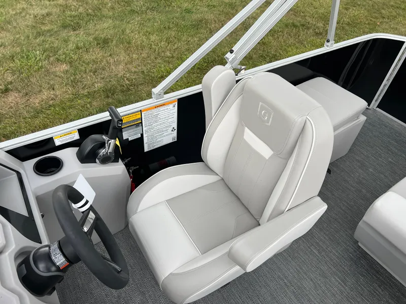 Slide: The Image of 2025 Godfrey Xperience 2086 FX boat interior with gray captain's chair and steering console. - 12