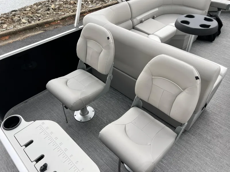 Slide: The Image of 2025 Godfrey Xperience 2086 FX boat interior with plush seating and fishing amenities. - 17