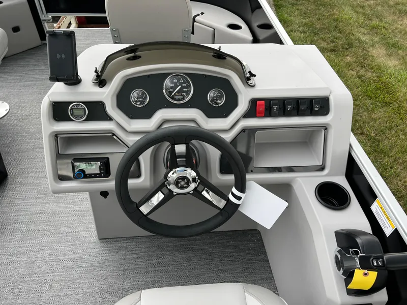 Slide: The Image of Godfrey Xperience 2086 FX 2025 boat dashboard with steering wheel and controls. - 19
