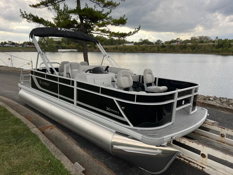 Slide: The Image of 2025 Godfrey Xperience 2086 FX pontoon boat docked by a serene lake. - 3