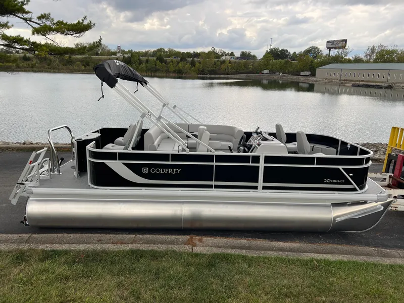 Slide: The Image of 2025 Godfrey Xperience 2086 FX pontoon boat docked by a serene lake. - 4