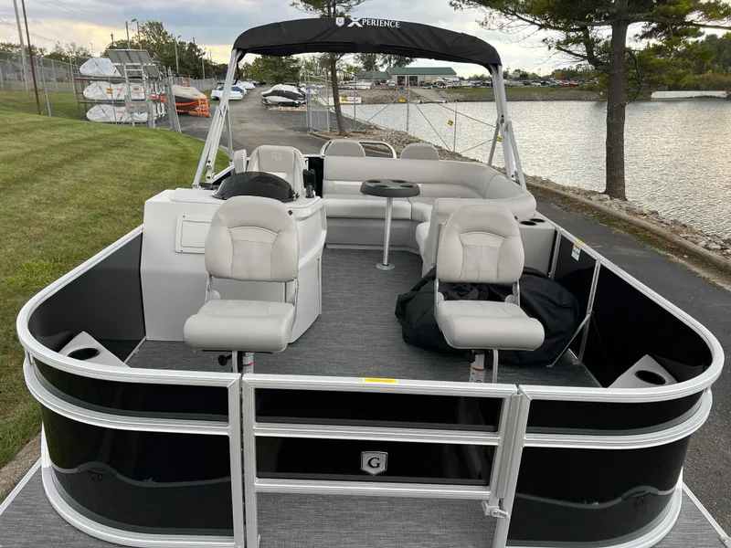 Slide: The Image of 2025 Godfrey Xperience 2086 FX pontoon boat docked by a lakeside. - 7