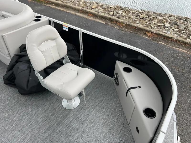 Slide: The Image of 2025 Godfrey Xperience 2086 FX boat interior with swivel seat and storage. - 9