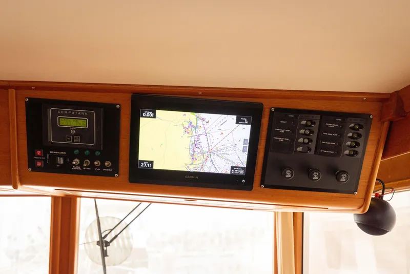 Slide: The Image of 2005 Grand Banks Europa helm with navigation and control panels. - 16