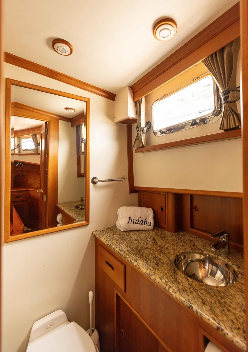 Slide: The Image of Luxurious 2005 Grand Banks Europa yacht bathroom with granite countertop and wooden cabinetry. - 22