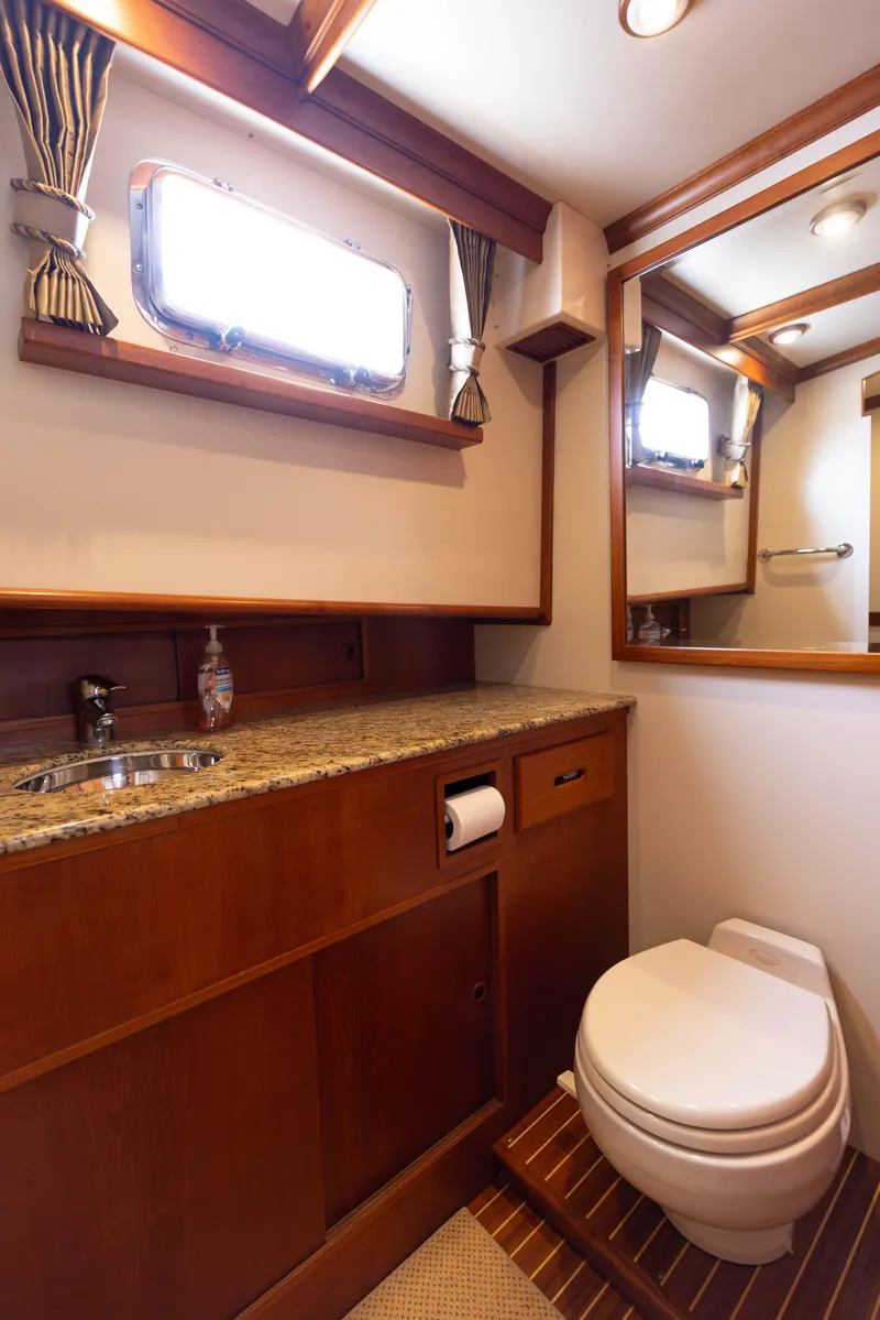 Slide: The Image of Luxurious 2005 Grand Banks Europa yacht bathroom with wood accents and granite countertop. - 23