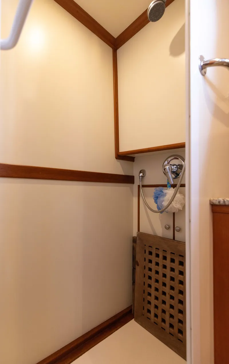 Slide: The Image of 2005 Grand Banks Europa shower with wooden accents and modern fixtures. - 26