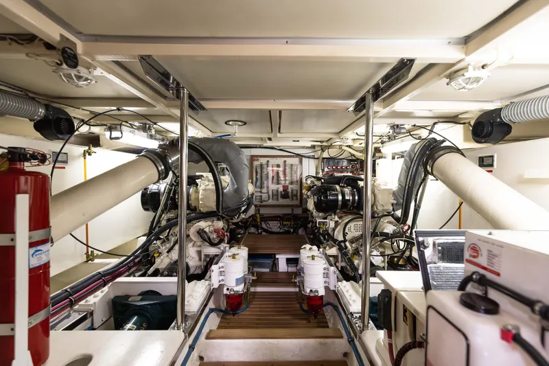 Slide: The Image of Engine room of 2005 Grand Banks Europa yacht, showcasing dual engines and mechanical systems. - 27
