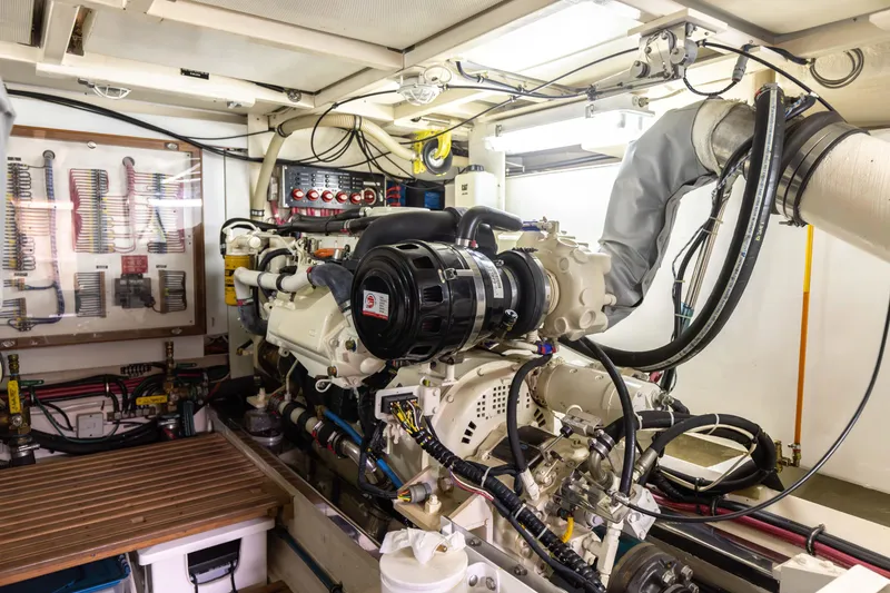 Slide: The Image of Engine room of 2005 Grand Banks Europa yacht, showcasing detailed mechanical components and tools. - 30