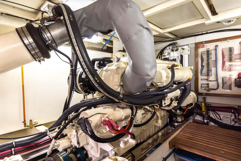 Slide: The Image of Engine room of 2005 Grand Banks Europa yacht, showcasing complex machinery and piping. - 31