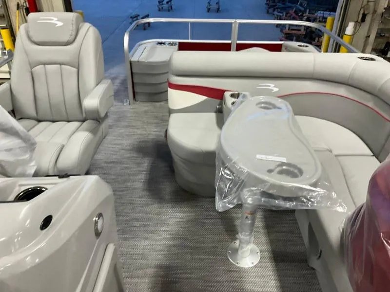 Slide: The Image of 2023 Bennington 20SVF pontoon boat interior with seating and table. - 11